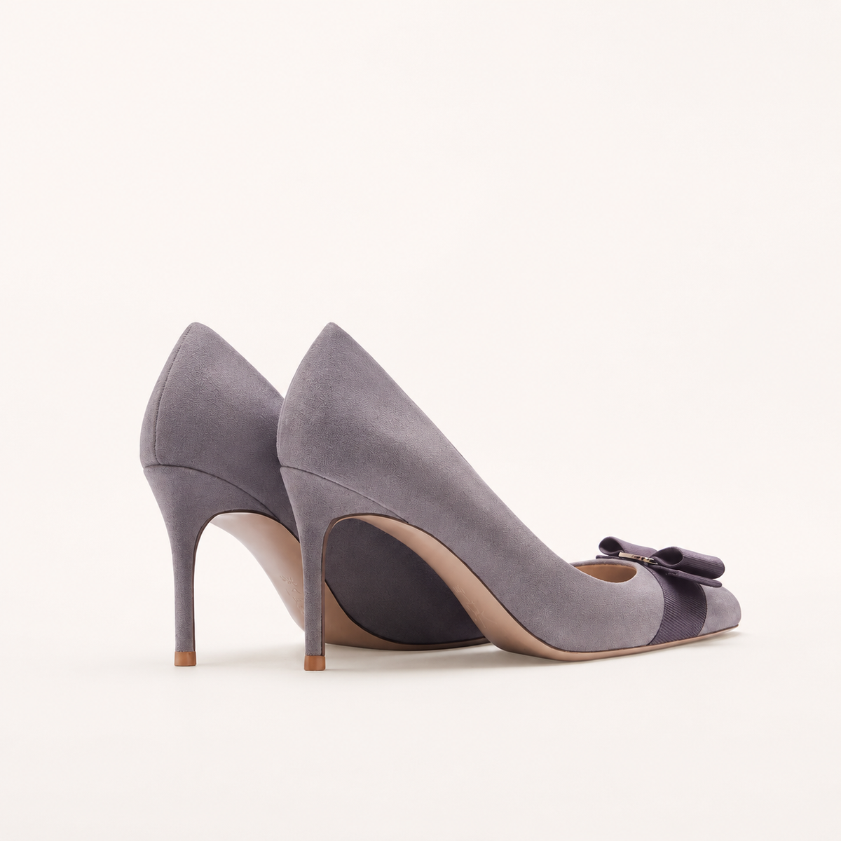 Faux suede bow pumps with round toe design