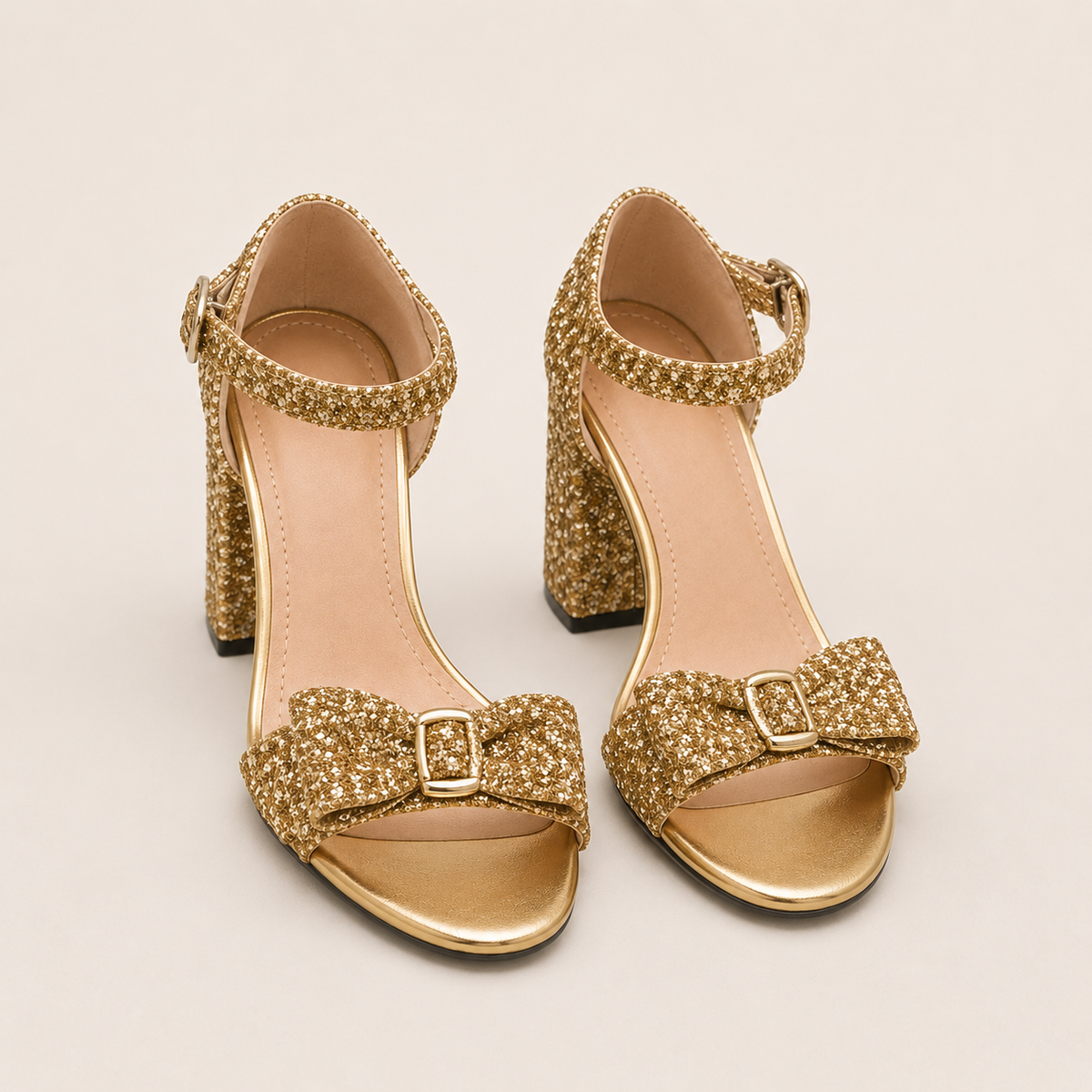 Patent high heel mules with bow in gold and silver metallic finish