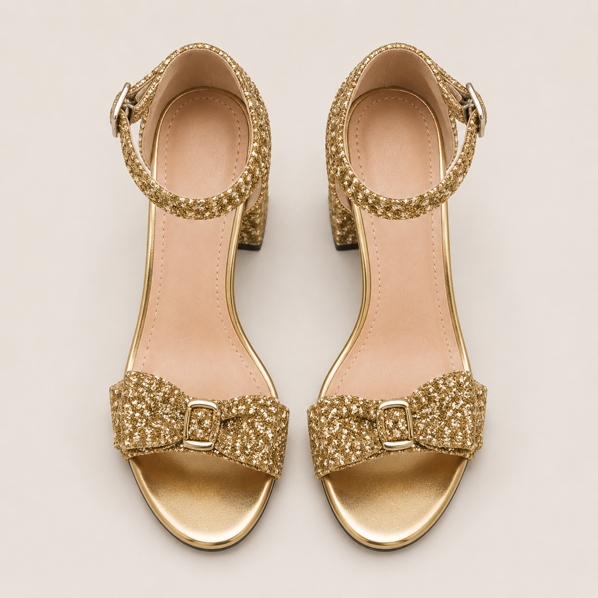 Patent high heel mules with bow in gold and silver metallic finish