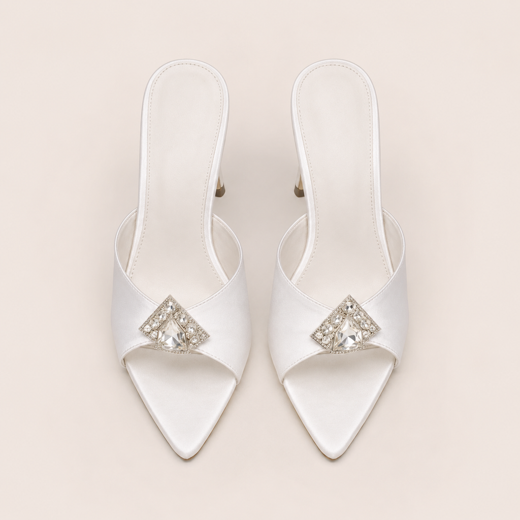 White satin sandals with rhinestone accents and stiletto heel