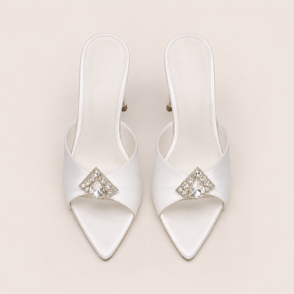 White satin sandals with rhinestone accents and stiletto heel