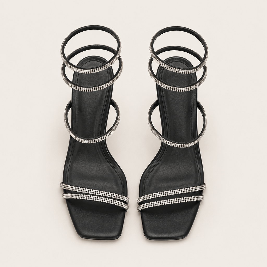 Sculptural snake heel sandals with signature designer detail