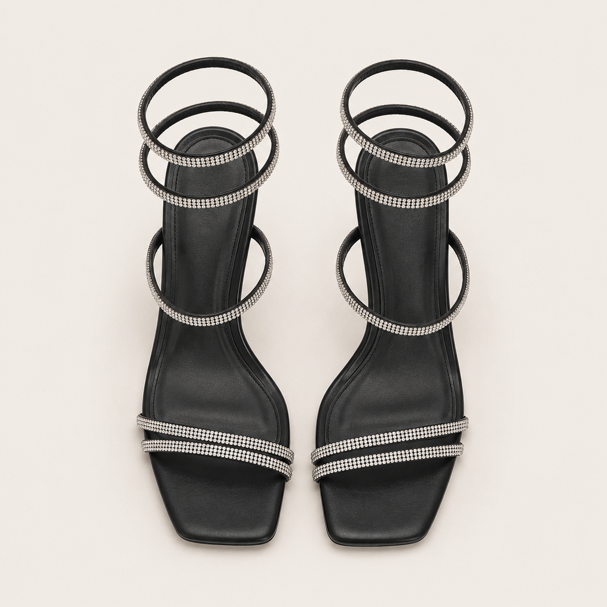 Sculptural snake heel sandals with signature designer detail