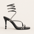 Sculptural snake heel sandals with signature designer detail