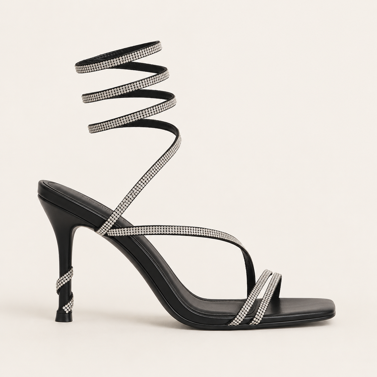 Sculptural snake heel sandals with signature designer detail